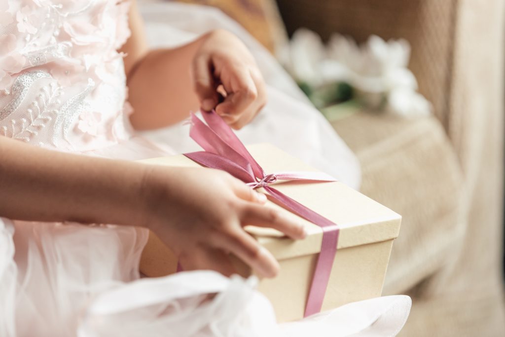 young-girl-opening-gift_4460x4460